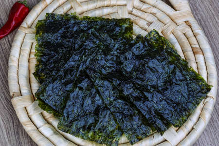 Korean traditional snack - Nori seaweed sheets on the wood backgroundの写真素材