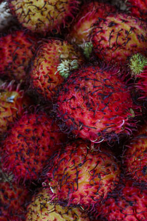 Asian fruit - rambutan - on the wood backgroundの写真素材