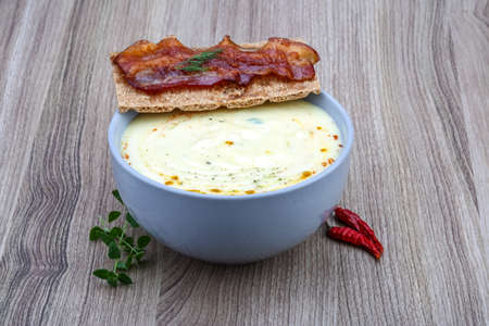 Cheese soup with roast bacon, herbs and spicesの写真素材