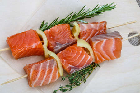 Fresh raw salmon skewer with pepper and rosemaryの写真素材