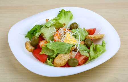 Caesar salad with tiger prawn on the wood backgroundの写真素材