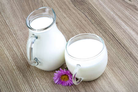 Fresh cold milk in glass on the wood backgroundの写真素材