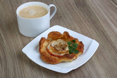 Fresh baked Apple pastry with coffee on the wood backgroundの写真素材