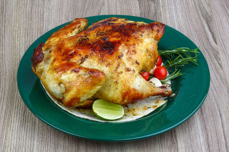 Hot tasty Grilled chicken with rosemary, lime and tomato