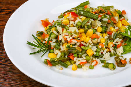 Mexican rice with vegetables and salad leavesの写真素材