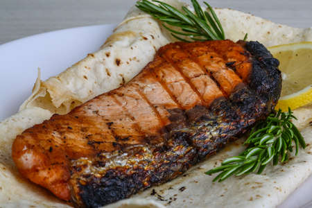 Grilled salmon with dill, lemon and breadの写真素材