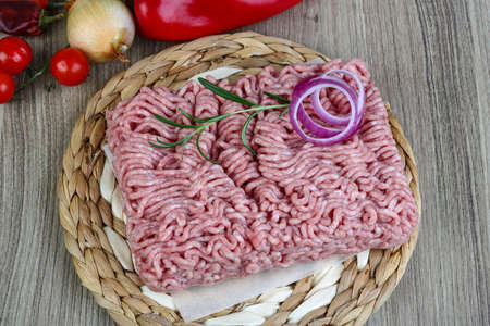 Raw minced pork meat with onion and rosemary ready for cooking