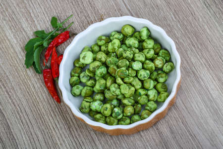 Japan traditional cuisime - Wasabi peas on the wood background
