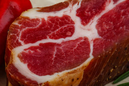 Chuck steak with rosemary, pepper and garlik on wood backgroundの写真素材