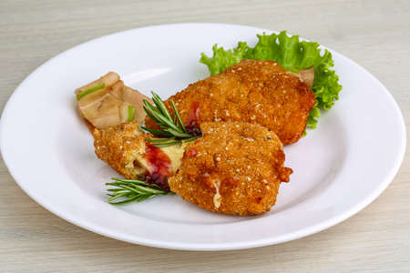 Fried cheese sticks in pan with rosemary