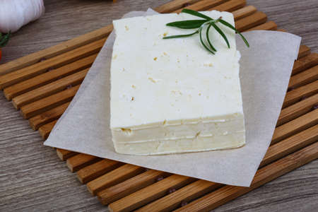 Traditional Caucasian homemade Cheese Brinza with rosemary on wood backgroundの写真素材
