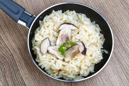 Mushroom risotto with parsley on the wood backgroundの写真素材
