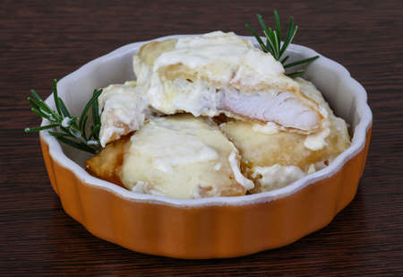 Baked perch in cream and cheese sauce with rosemary and lemonの写真素材