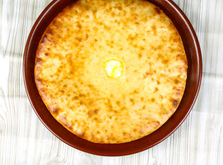 Traditional Caucasian cuisine - hot Ossetian pie in the bowlの写真素材