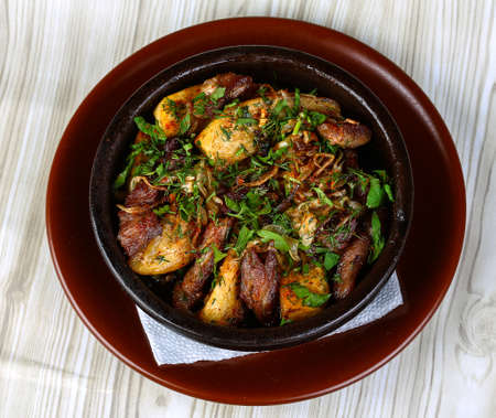 Baked potato with pork meat served fresh herbsの写真素材