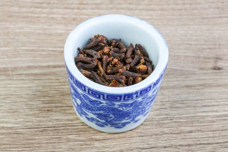 Aromatic Dried Cloves seeds on the wood backgroundの写真素材