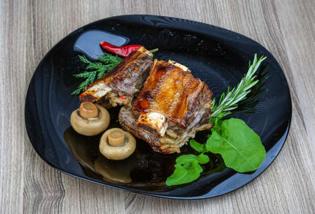 Roasted beef ribs with rosemary, ruccola and spicesの写真素材