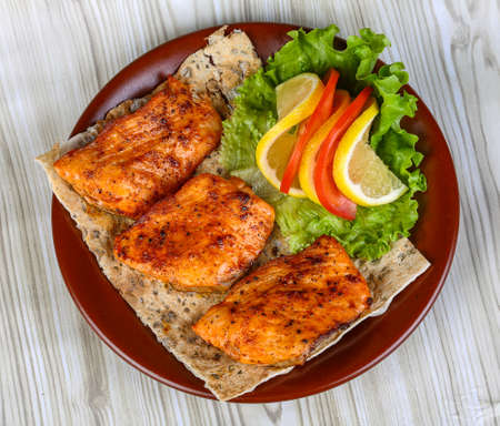 Chicken breast bbq with salad leaves, tomato and lemonの写真素材