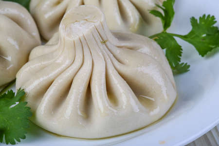 Caucasuan cuisine - Khinkali with meat served green koriander leavesの写真素材