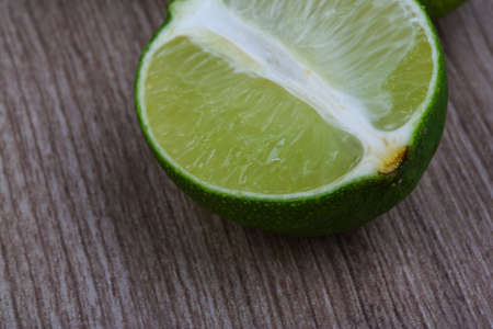 Tropical fruit - green sloced lime on the wood backgroundの写真素材