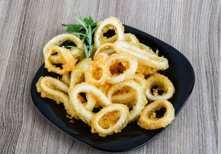 Tempura - squid rings served green onion and rucola leavesの写真素材