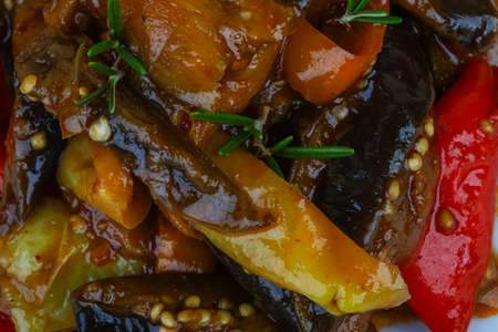 Roasted vegetables with herbs and spices on the wood backgroundの写真素材