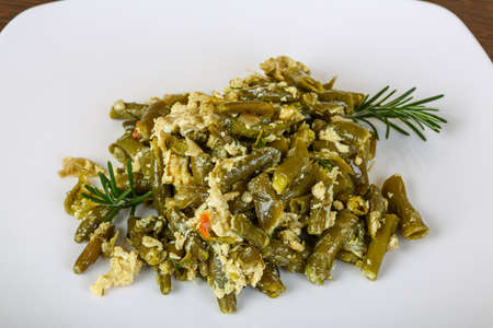 Roast green beans with egg served rosemary branchの写真素材