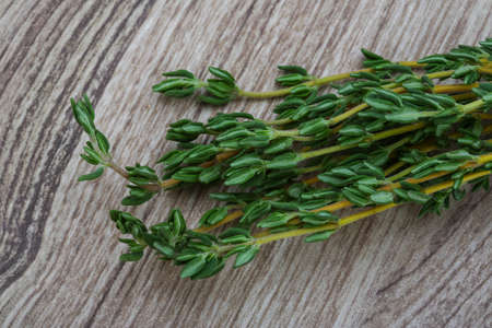 Fresh green Thyme branch on the wood backgroundの写真素材