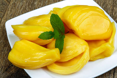 Jackfruit with mint leaves in the bowl on wood background