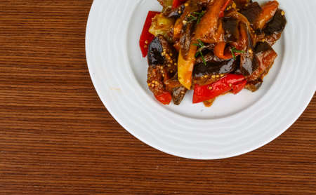 Roasted vegetables with herbs and spices on the wood backgroundの写真素材