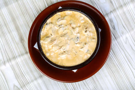 Cocotte julienne with mushrooms, chicken, cream and cheeseの写真素材