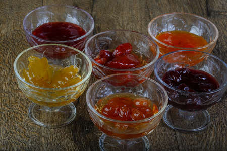Jam assortie on the wood background