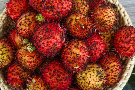 Asian fruit - rambutan - on the wood backgroundの写真素材