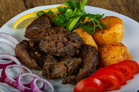 Hot juicy grilled liver with potatoの写真素材
