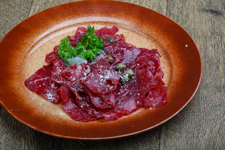 Beef carpaccio with cheeese and parsley leavesの写真素材