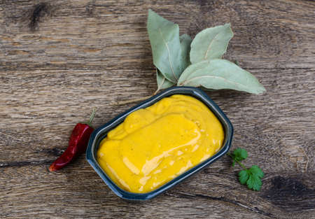 Curry sause with red pepper and coriander seeds on wood backgroundの写真素材