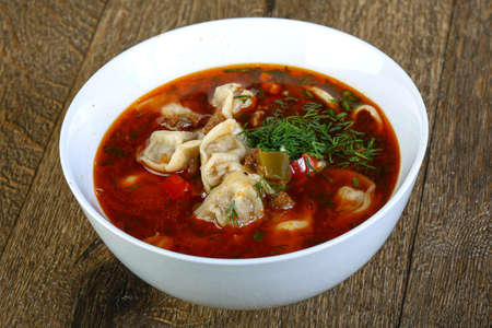 Dumpling soup with tomato and other vegetables