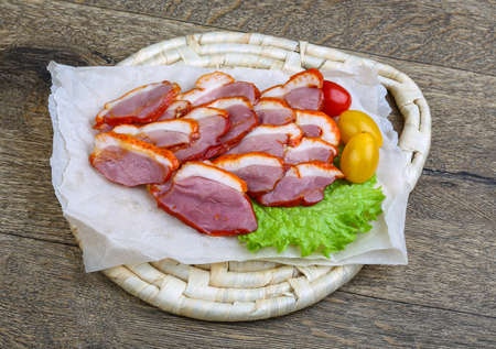 Cliced duck breast with salad leaves on the wood backgroundの写真素材