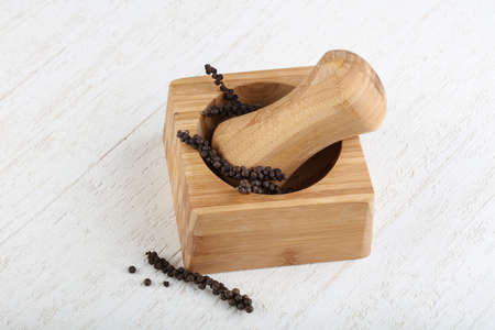 Mortar with black pepper on the wood backgroundの写真素材