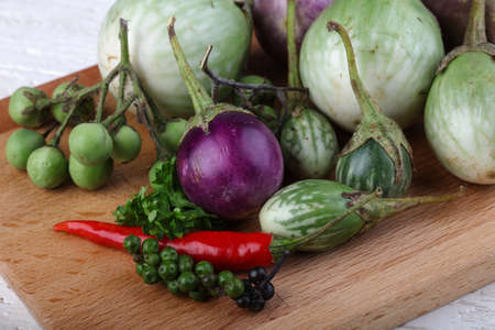 Fresh ripe Baby eggplans on the wood backgroundの写真素材