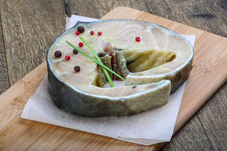 Raw strugeon steak with pepper and spices ready for cookingの写真素材
