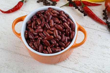Dry kidney in the bowl on wood background