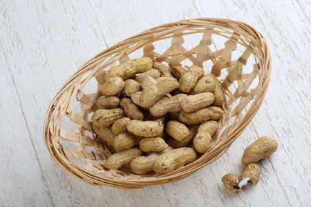 Peanuts in the bowl on the wood backgroundの写真素材
