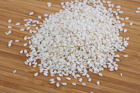 Sesame seeds heap on the wood backgroundの写真素材