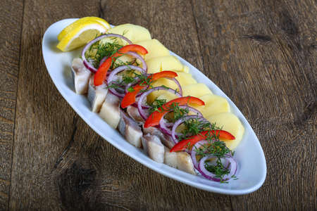 Herring fillet with potato, onion and pepperの写真素材