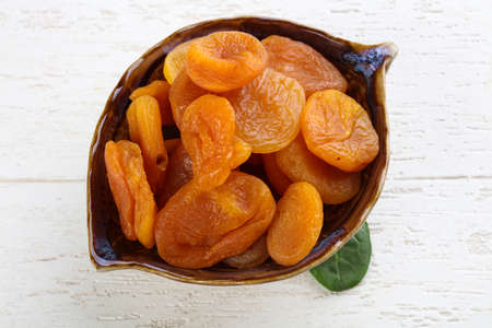 Bright vivid Dried apricots on the wood backgroundの写真素材