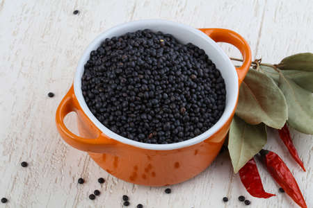 Raw Black lentils on the wood backgroundの写真素材