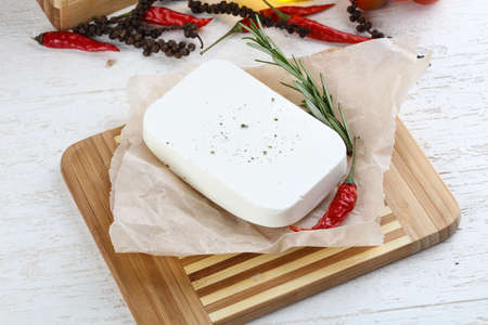 Feta cheese piece on the wood backgroundの写真素材