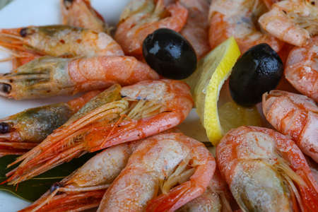 Boiled shrimps snack - appetiser served lemon and olivesの写真素材
