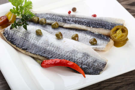 Herring fillet with capers, parsley and pepperの写真素材